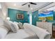 Spacious main bedroom with teal walls, large TV, and comfortable bedding at 206 Church Ave, Bradenton Beach, FL 34217
