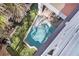 Aerial view of a private pool and patio, surrounded by lush landscaping at 206 Church Ave, Bradenton Beach, FL 34217