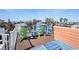 Bright rooftop deck featuring colorful Adirondack chairs and an ocean view at 206 Church Ave, Bradenton Beach, FL 34217