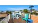 Ocean view rooftop deck with patio furniture, perfect for relaxing and enjoying the breeze at 206 Church Ave, Bradenton Beach, FL 34217