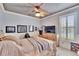 Bright bedroom with wood flooring, ceiling fan, and large TV at 214 Bon Vie Pl, Valrico, FL 33594