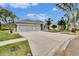 Two-car garage, gray exterior, nicely landscaped yard at 214 Bon Vie Pl, Valrico, FL 33594