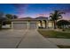 Two-story house with a two-car garage and landscaped yard at 214 Bon Vie Pl, Valrico, FL 33594