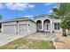 Two-story house with a two-car garage and a stone patio at 214 Bon Vie Pl, Valrico, FL 33594