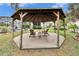 Wooden gazebo with seating in the backyard at 214 Bon Vie Pl, Valrico, FL 33594