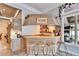 L-shaped home bar with wood accents and a granite countertop at 214 Bon Vie Pl, Valrico, FL 33594