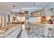 Home bar with wooden cabinetry, granite countertop, and three rustic stools at 214 Bon Vie Pl, Valrico, FL 33594