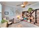 Home office with a large wooden shelving unit, comfortable chairs, and a world map at 214 Bon Vie Pl, Valrico, FL 33594
