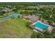 Aerial view of community amenities including pool, tennis courts, and clubhouse at 2424 Dakota Rock Dr, Ruskin, FL 33570