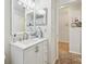 Clean bathroom with white vanity, modern fixtures, and a mirror at 2424 Dakota Rock Dr, Ruskin, FL 33570