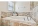 Relaxing bathtub with tile surround and window at 2424 Dakota Rock Dr, Ruskin, FL 33570