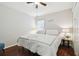 Bright bedroom featuring a king-size bed and wood flooring at 2424 Dakota Rock Dr, Ruskin, FL 33570