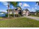 House exterior showcasing a two-car garage and palm trees at 2424 Dakota Rock Dr, Ruskin, FL 33570