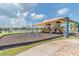 Community playground with swings, slides, and covered seating at 2424 Dakota Rock Dr, Ruskin, FL 33570