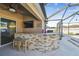 Outdoor kitchen and pool with covered patio at 2424 Dakota Rock Dr, Ruskin, FL 33570