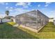 Screened pool enclosure with patio furniture and string lights at 2424 Dakota Rock Dr, Ruskin, FL 33570