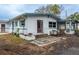 Home's back view with patio and mature tree at 2744 45Th S St, Gulfport, FL 33711