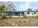 Home's back view with screened porch and mature tree at 2744 45Th S St, Gulfport, FL 33711
