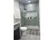 Modern bathroom with a large glass shower, gray tile, and gray vanity at 3005 E 148Th Ave, Lutz, FL 33559