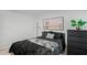 Well-lit bedroom featuring a comfortable bed and wall art at 30148 Fedora Cir, Brooksville, FL 34602
