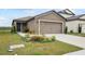 One-story home with a two-car garage and landscaped front yard at 30148 Fedora Cir, Brooksville, FL 34602