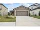 One-story home with a two-car garage and landscaped front yard at 30148 Fedora Cir, Brooksville, FL 34602