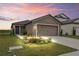 One-story home with a two-car garage and landscaped front yard at 30148 Fedora Cir, Brooksville, FL 34602