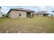 Backyard view of house with covered patio and grassy yard at 30148 Fedora Cir, Brooksville, FL 34602