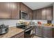 Modern kitchen with stainless steel appliances and granite countertops at 30148 Fedora Cir, Brooksville, FL 34602