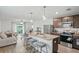 Open concept kitchen with island, stainless steel appliances, and granite countertops at 30148 Fedora Cir, Brooksville, FL 34602