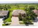 Aerial view of a single-Gathering home with a large yard and conservation area behind at 32202 Summerglade Dr, Wesley Chapel, FL 33545