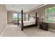 Main bedroom with large four poster bed and neutral color palette at 32202 Summerglade Dr, Wesley Chapel, FL 33545