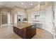 Kitchen features granite countertops,dark wood island, and white cabinetry at 32202 Summerglade Dr, Wesley Chapel, FL 33545