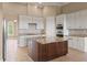 Kitchen boasts island, white cabinets, and stainless steel appliances at 32202 Summerglade Dr, Wesley Chapel, FL 33545