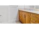 Bathroom with wood vanity, granite countertop, and tiled shower at 331 Cleveland St # 315, Clearwater, FL 33755