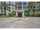 Modern building exterior with palm trees and paved courtyard at 331 Cleveland St # 315, Clearwater, FL 33755
