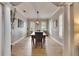 Bright dining room featuring a rustic wood table and chandelier at 5409 Cafrey Pl, Apollo Beach, FL 33572