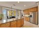 Bright kitchen features granite counters, light wood cabinets, and stainless steel appliances at 5409 Cafrey Pl, Apollo Beach, FL 33572