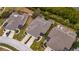 Aerial view of three villas with screened patios, showcasing community layout at 5610 Golden Isles Dr, Apollo Beach, FL 33572