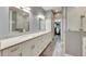 Bright bathroom boasts double vanity, quartz countertops, and a walk-in shower at 5610 Golden Isles Dr, Apollo Beach, FL 33572