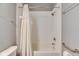 Simple bathroom with a shower/tub combo and white tile at 5610 Golden Isles Dr, Apollo Beach, FL 33572