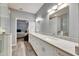 Elegant bathroom with double vanity, quartz countertops, and a large walk-in shower at 5610 Golden Isles Dr, Apollo Beach, FL 33572