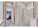 Modern bathroom featuring a walk-in shower and access to a large closet at 5610 Golden Isles Dr, Apollo Beach, FL 33572