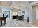 Open concept dining room with hardwood floors and modern light fixture at 5610 Golden Isles Dr, Apollo Beach, FL 33572