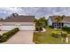 Two-car garage with driveway and manicured landscaping at 5610 Golden Isles Dr, Apollo Beach, FL 33572