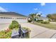 Two-car garage with driveway and manicured landscaping at 5610 Golden Isles Dr, Apollo Beach, FL 33572