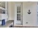 White exterior door with louvered shutters and nautical decor at 5610 Golden Isles Dr, Apollo Beach, FL 33572