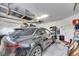 Garage with car, overhead storage, and shelving at 5610 Golden Isles Dr, Apollo Beach, FL 33572