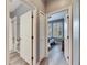 Bright hallway with doors to bedroom and bathroom, featuring light grey walls and hardwood floors at 5610 Golden Isles Dr, Apollo Beach, FL 33572