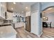 Modern kitchen, featuring white shaker cabinets, stainless steel appliances, and quartz countertops at 5610 Golden Isles Dr, Apollo Beach, FL 33572